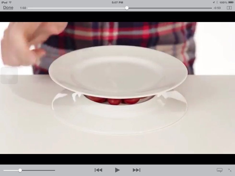Flip a plate over, put as many cherry tomatoes as you could in the 'hole' part of the plate. Then put another plate over the tomatoes to keep them in place.