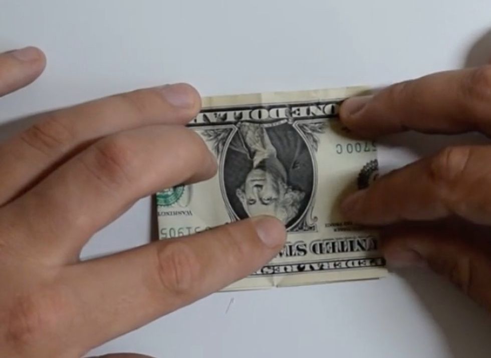Flip bill over and fold bottom right corner to the middle