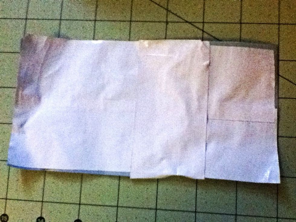 Flip both over so that it's facing what's going to be the inside. Tape them together length-wise. This will prevent any stickiness from happening at the bottom.