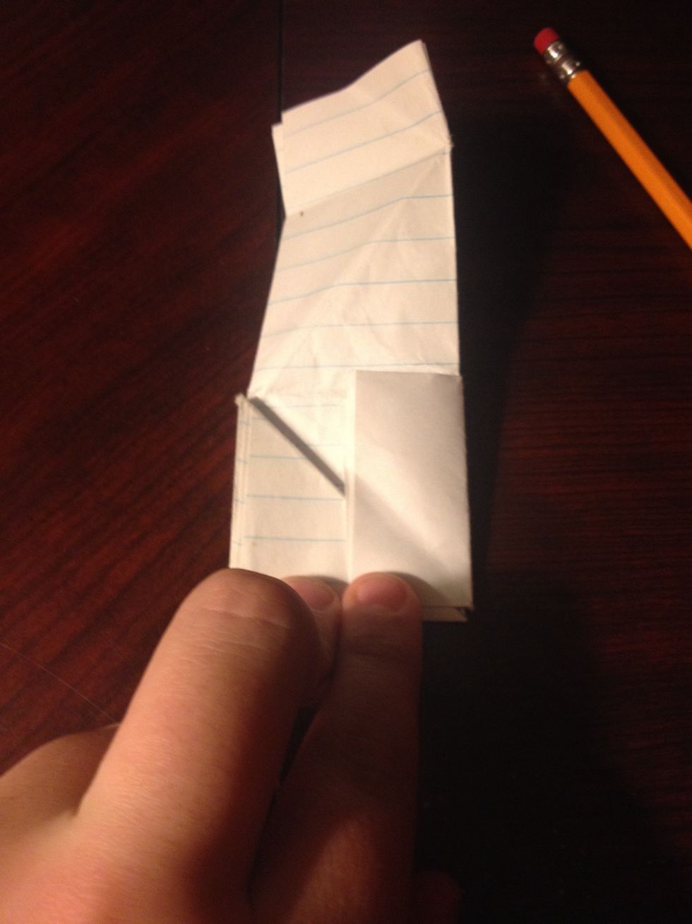 Flip it back over and the fold the small piece of paper at the edge of the square