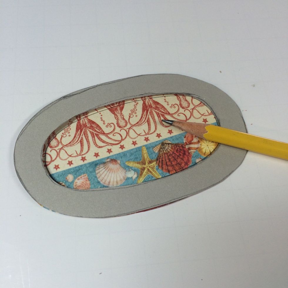 Flip it face down and trace the template's inner oval.