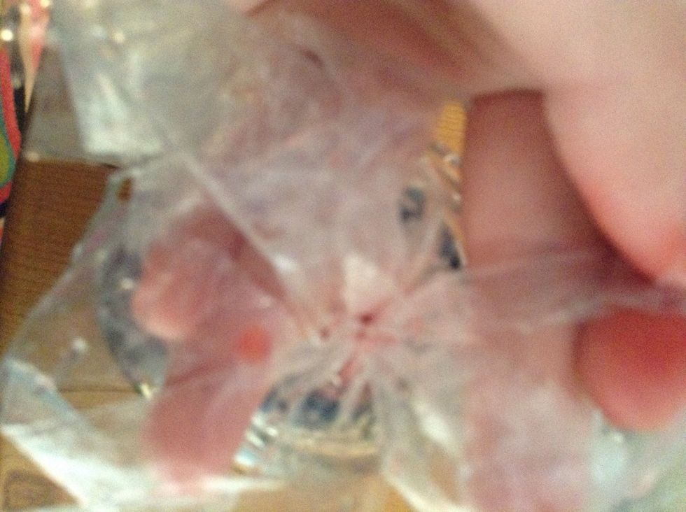 Flip it over and u will find a little hole fill it up with water and food coloring then tie it up with a piece of thread this time u want to do a triple or Quadruple knot the add it in the water