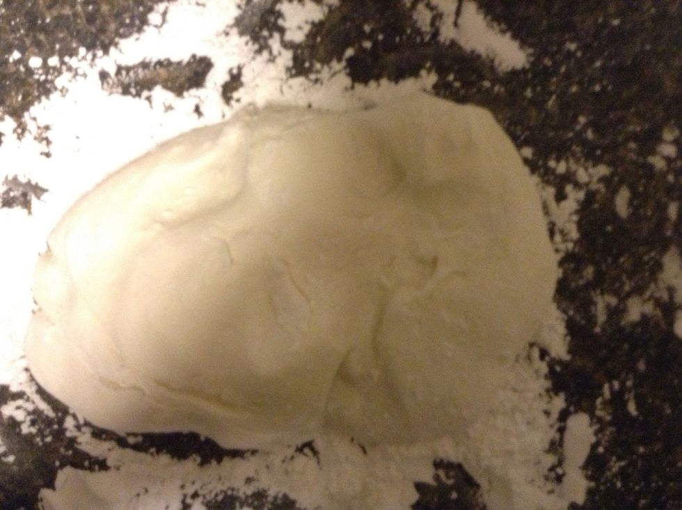 Flip mixture out onto a countertop dusted with the last 1/2 c of powdered sugar. Rub your hands with sugar and begin to knead like bread, or fold the mixture into itself.