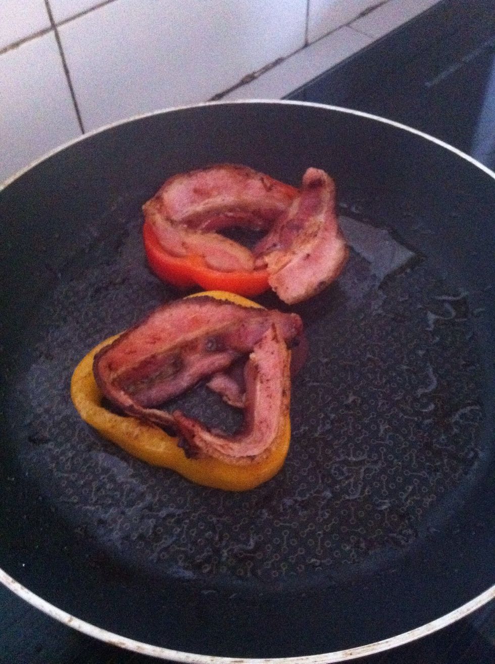 Flip over pepper and when it's still on the fire, arrange in bacon by surrounding it inside