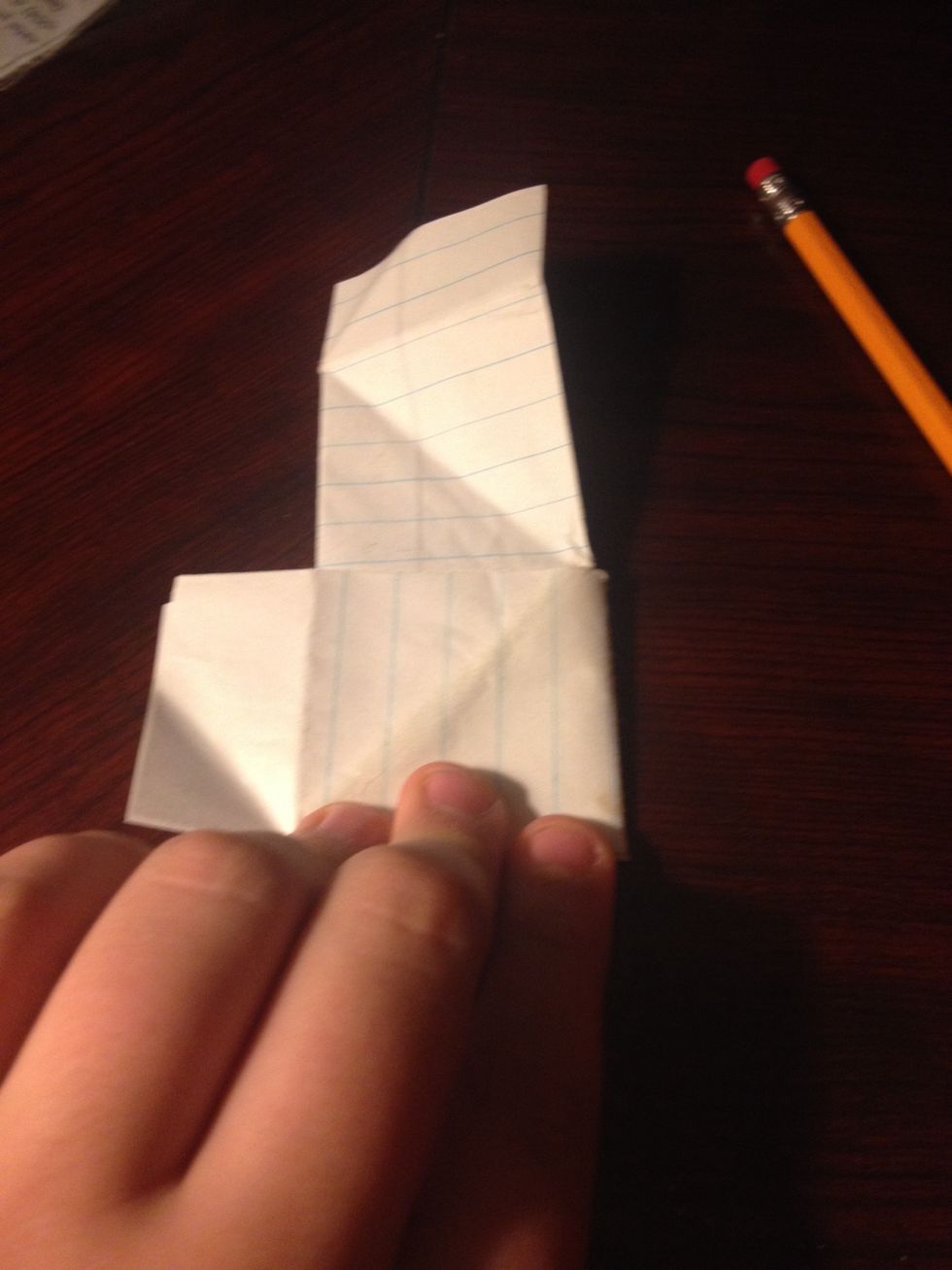 Flip over the paper and fold the extra paper around the back