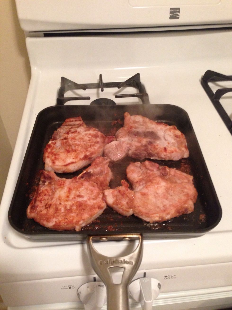 Flip over. The porkchops should look a nice whitish color. If you are unsure if they are done, cut the center of the biggest chop, it shouldn't have any pink and be white.