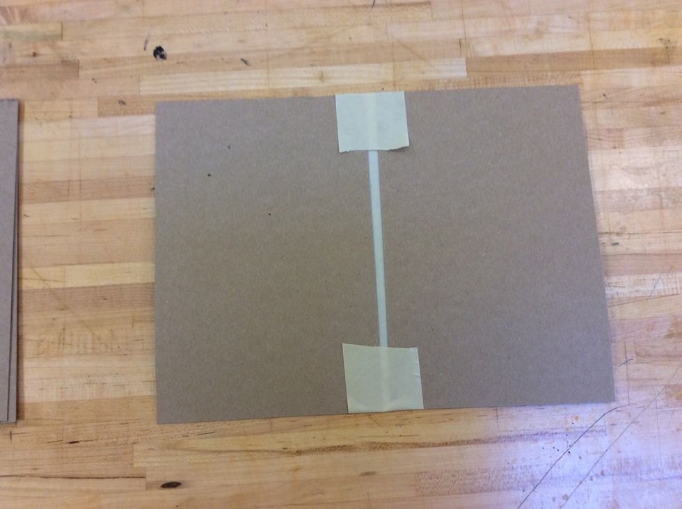 Flip over your cardboard cover and tuck the edges of the tape over onto the cardboard.