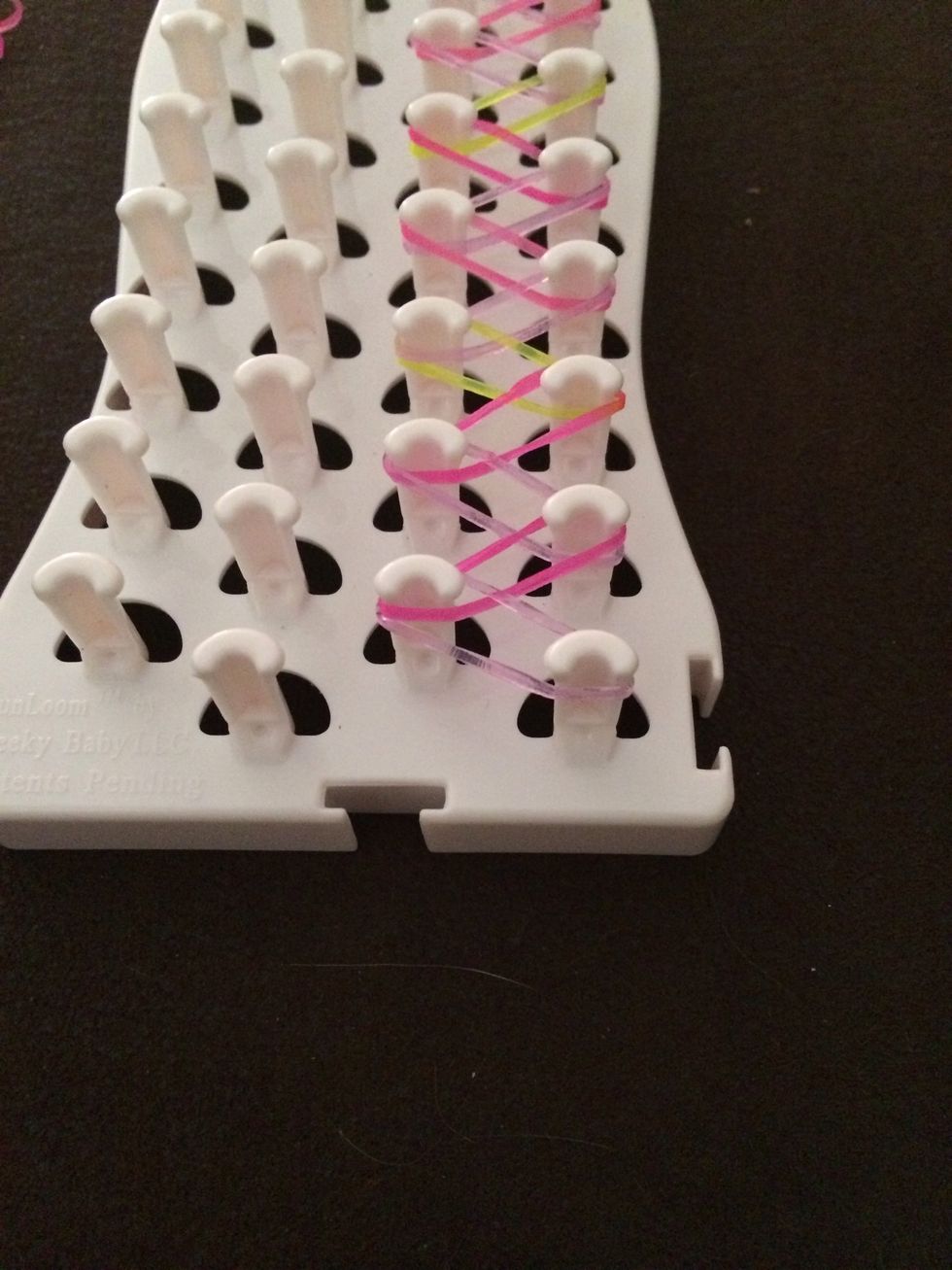 Flip over your loom board so that the pegs are facing you