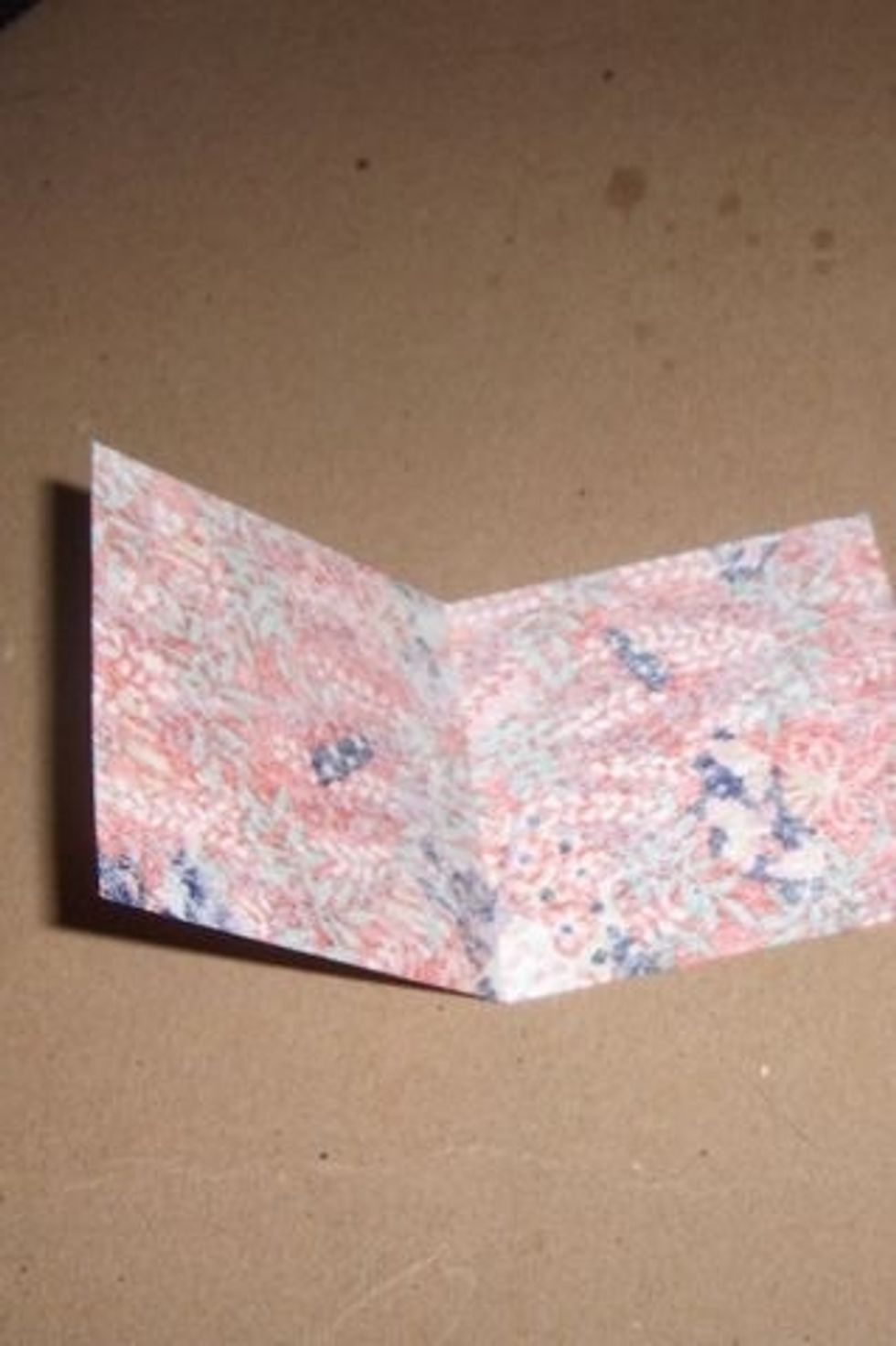 Flip paper good side down and fold in half.