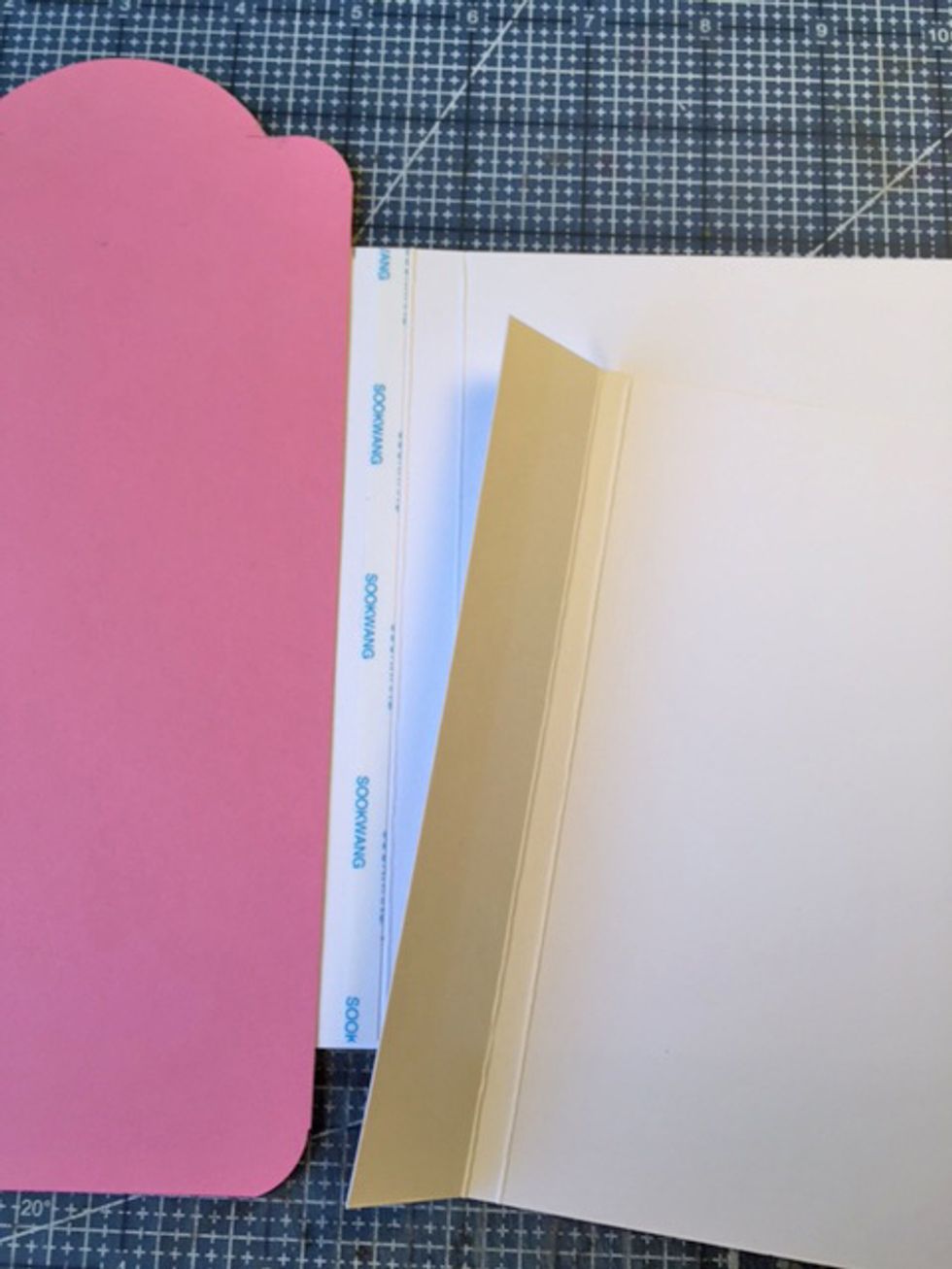 Flip tag over and repeat steps to add right flap. Attach the back of the flaps together with glue or adhesive.