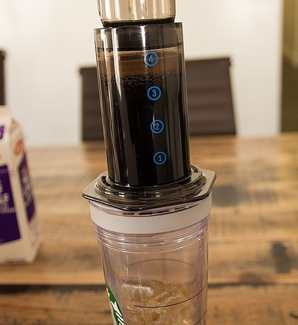Flip the AeroPress over carefully and place it into your cup. Begin plunging the coffee into the ice.