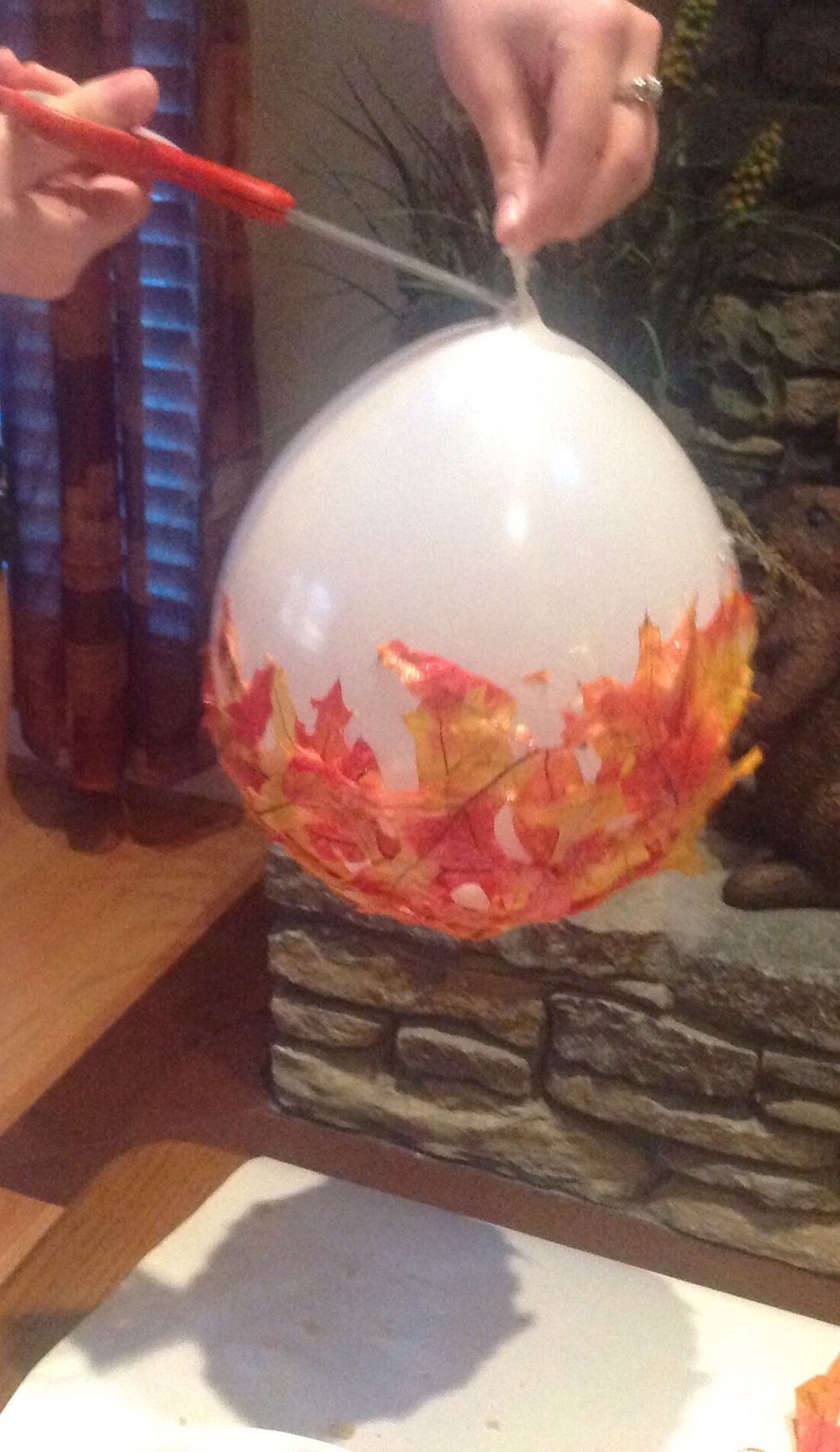 Flip the balloon over and cut a small slit near where you tied the balloon.