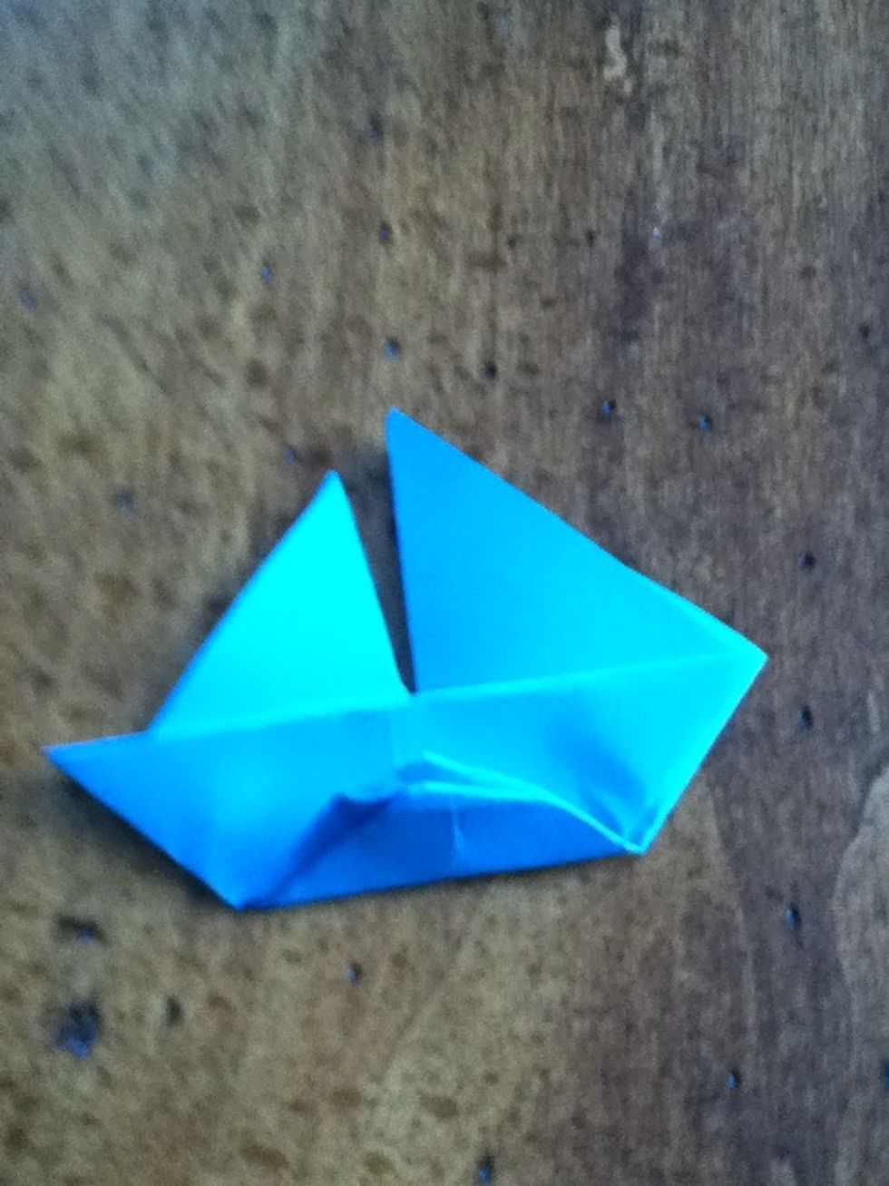 Flip the boat over. Fold the bottom of the hull to the top of it.