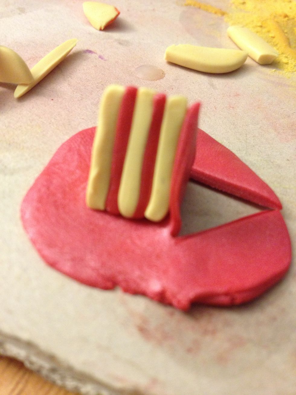 Flip the cake, still without slicing the third side. Then cut the icing to size on the cake that's touching it.