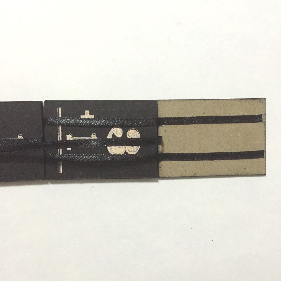 Flip the center ribbon over the 10th number block and glue the 2 ribbons over the 11th number block as shown... This is the end and you may want to trim the ribbons to fit within the chipboard...