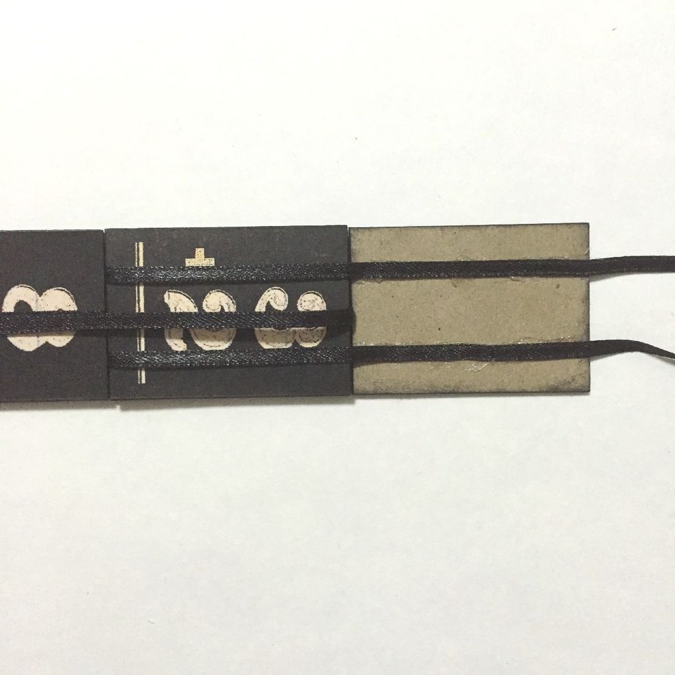 Flip the center ribbon over the 6th number block and glue the 2 ribbons over the 7th number block as shown...