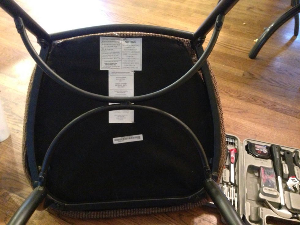 Flip the chair and unscrew the seat from the base.