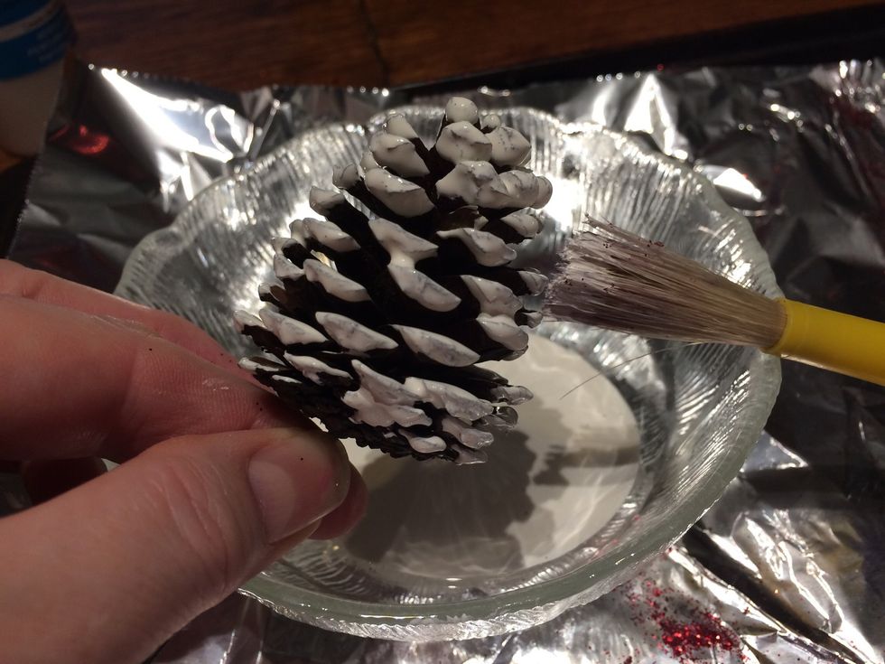 Flip the cone over and brush the paint down the tops of the scales. You want to use enough paint so it balls up a bit, but not enough where it drips.