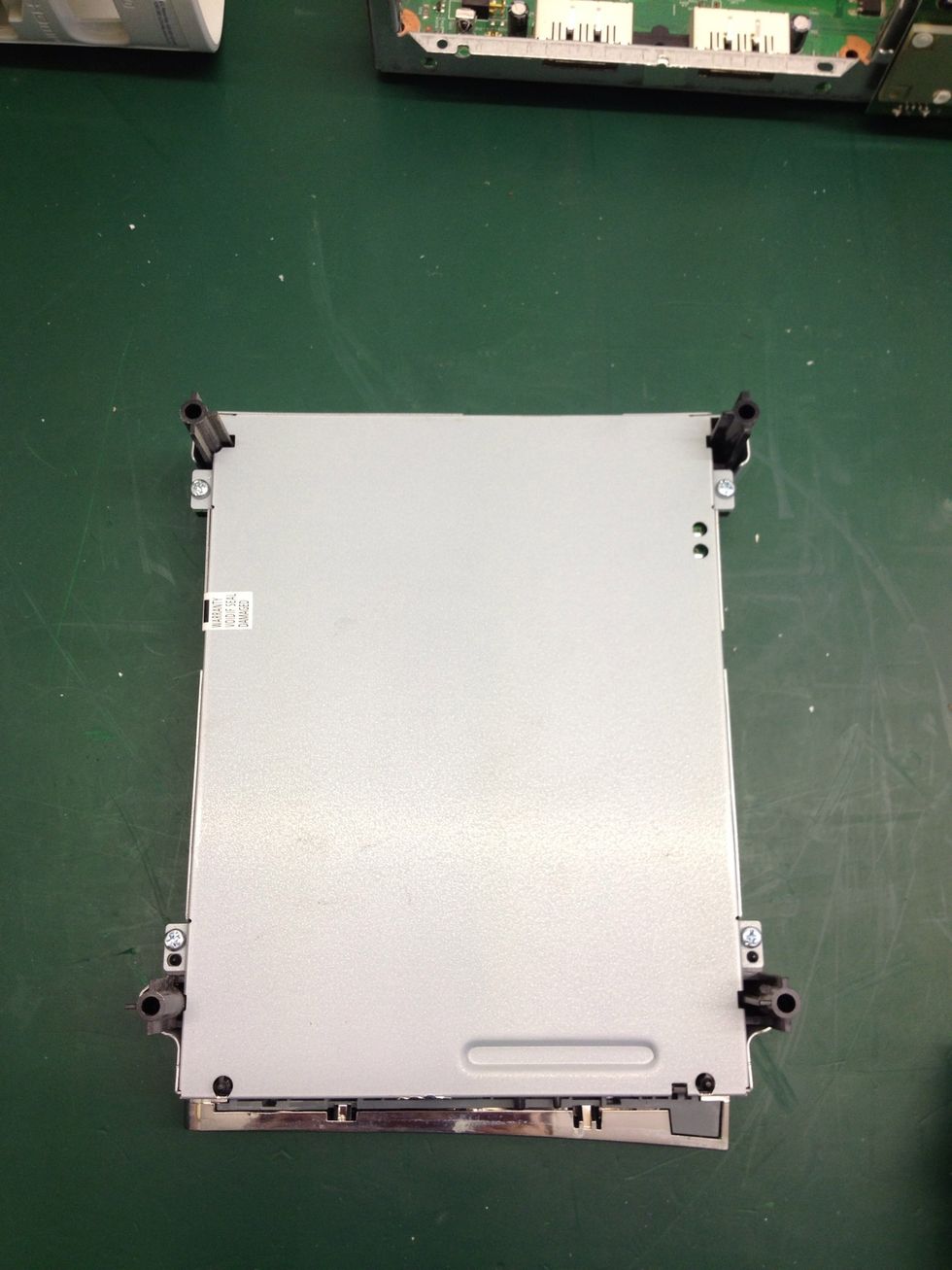 Flip the drive to show its belly and take note of the four screws located near each black plastic post and the warranty void sticker on the side.