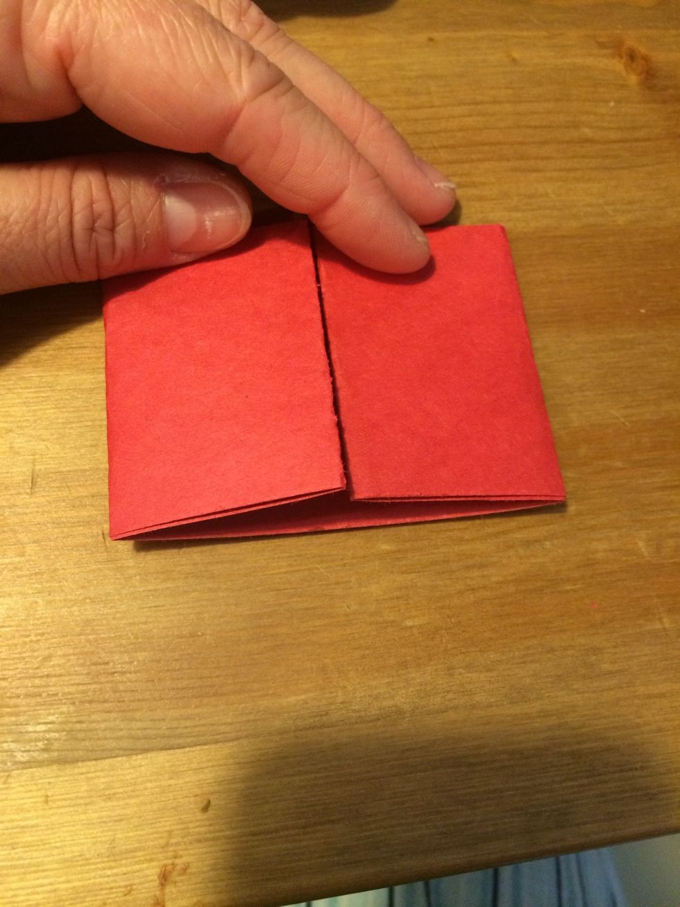 Flip the folded paper over and fold each end to the center, lined up with the crease.