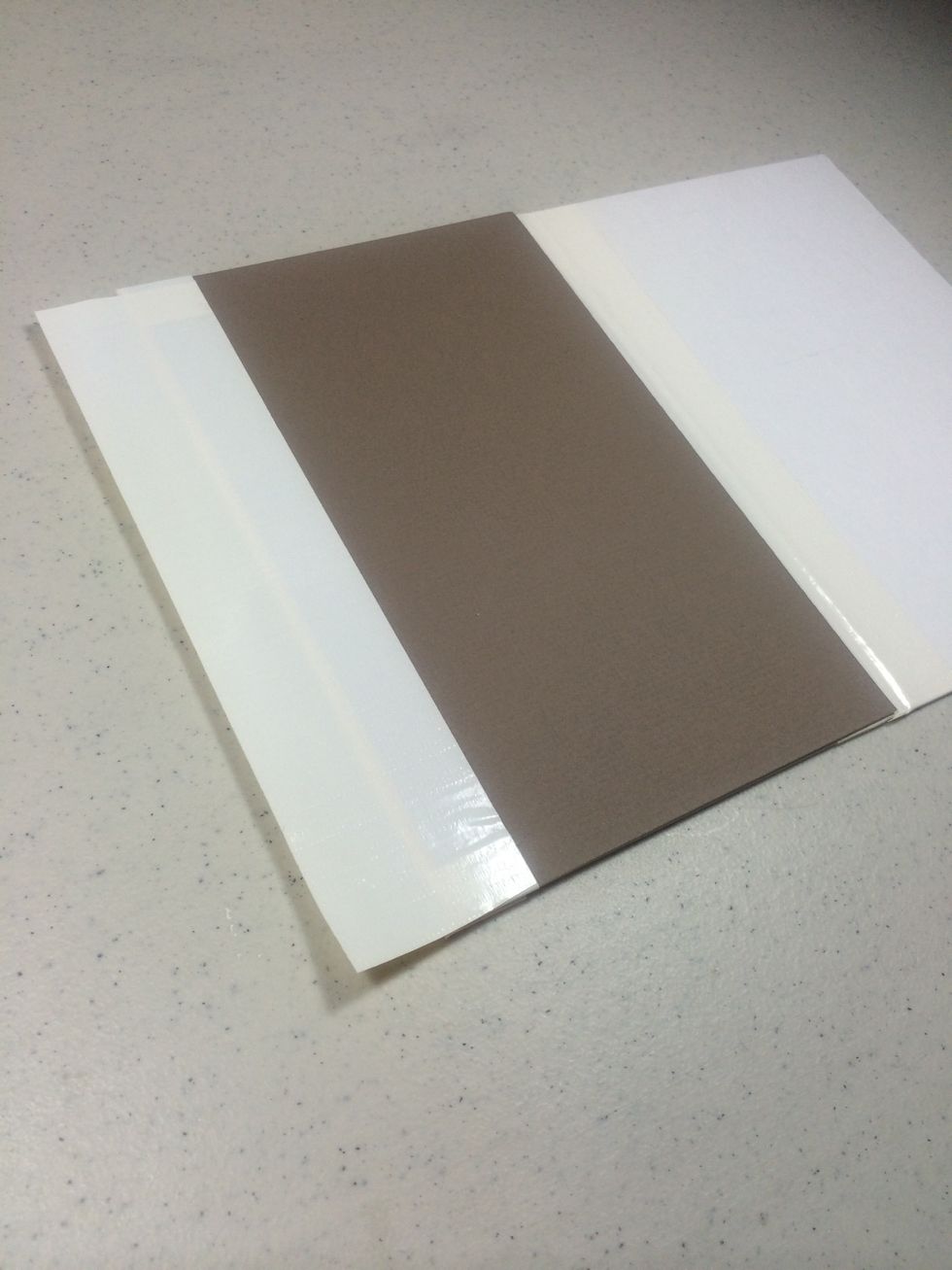 Flip the folio to show the interior again. Fold in the left panel and add another strip of white tape half way across.