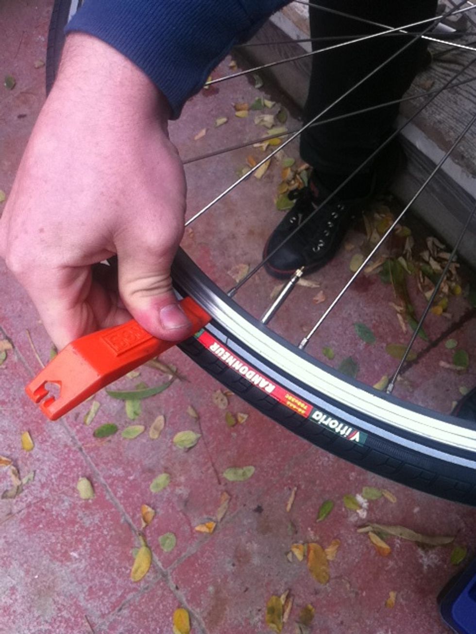 flip the lever up and push the rest of the tire on