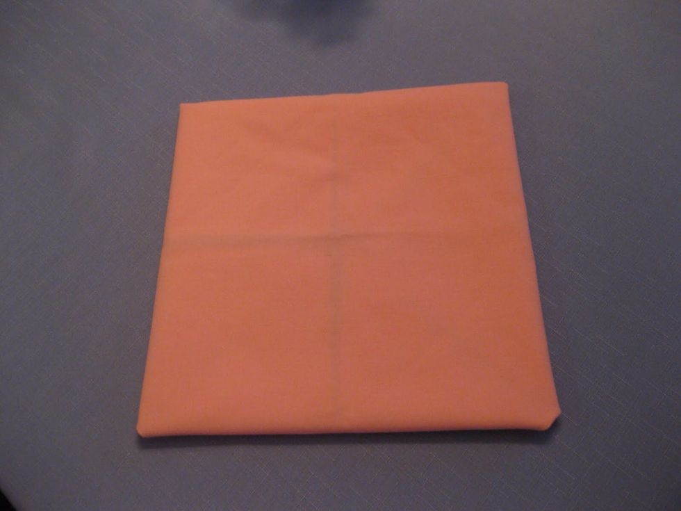 Flip the napkin over to the other side, facing the side you have been folding on down.