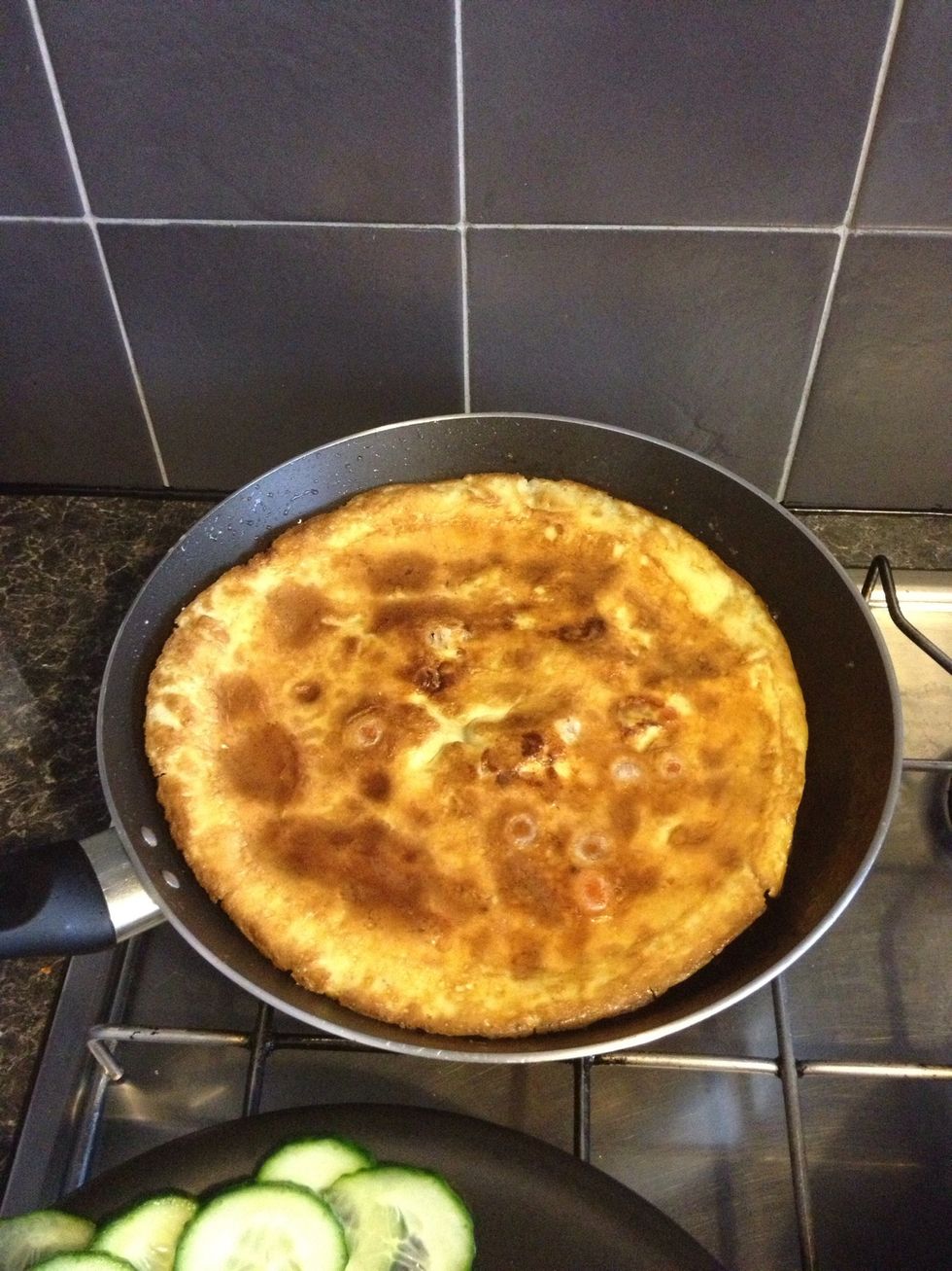 Flip the omelette when it becomes less runny (the photo is post flipping)