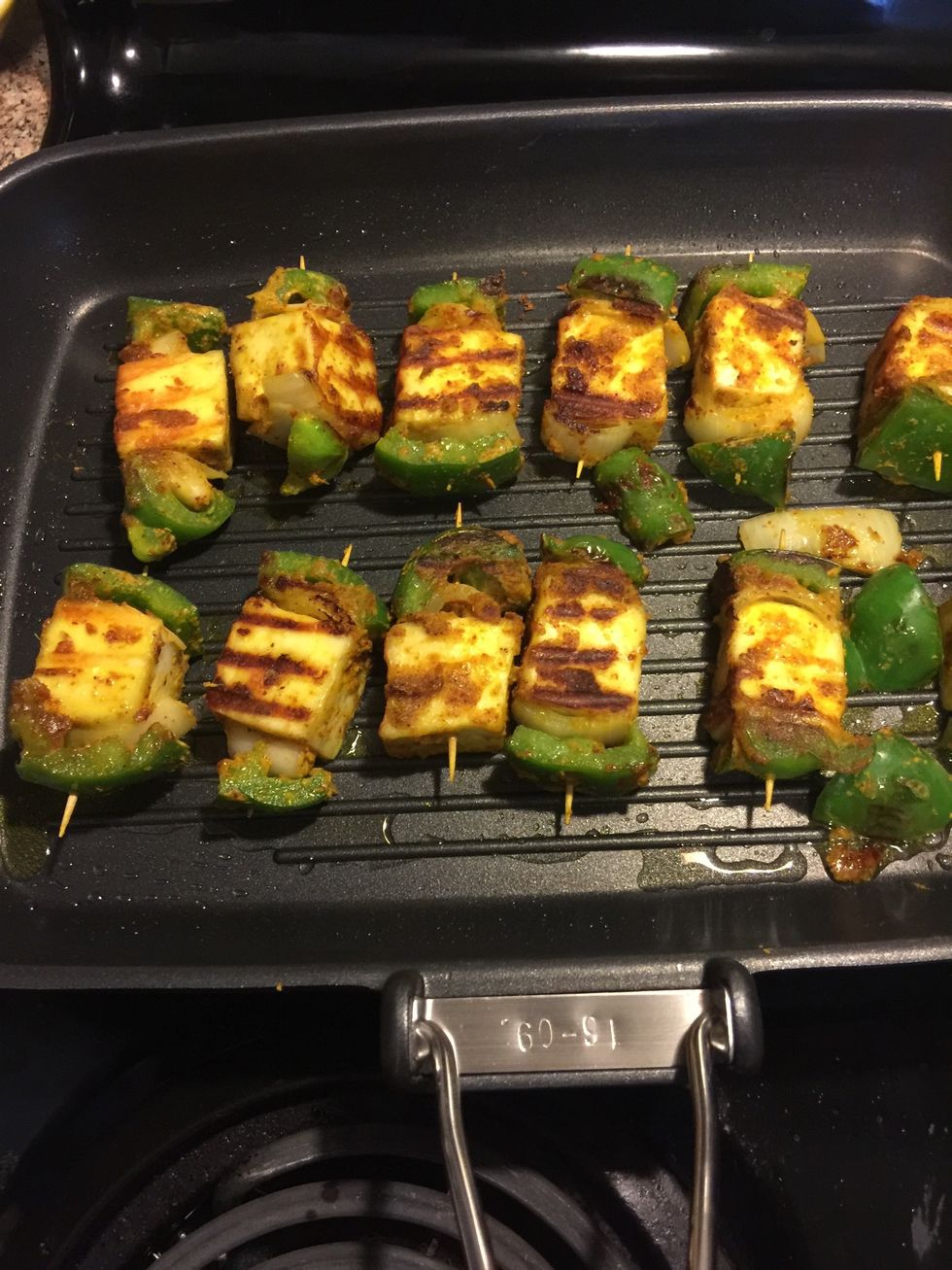 Flip the paneer tikkas.