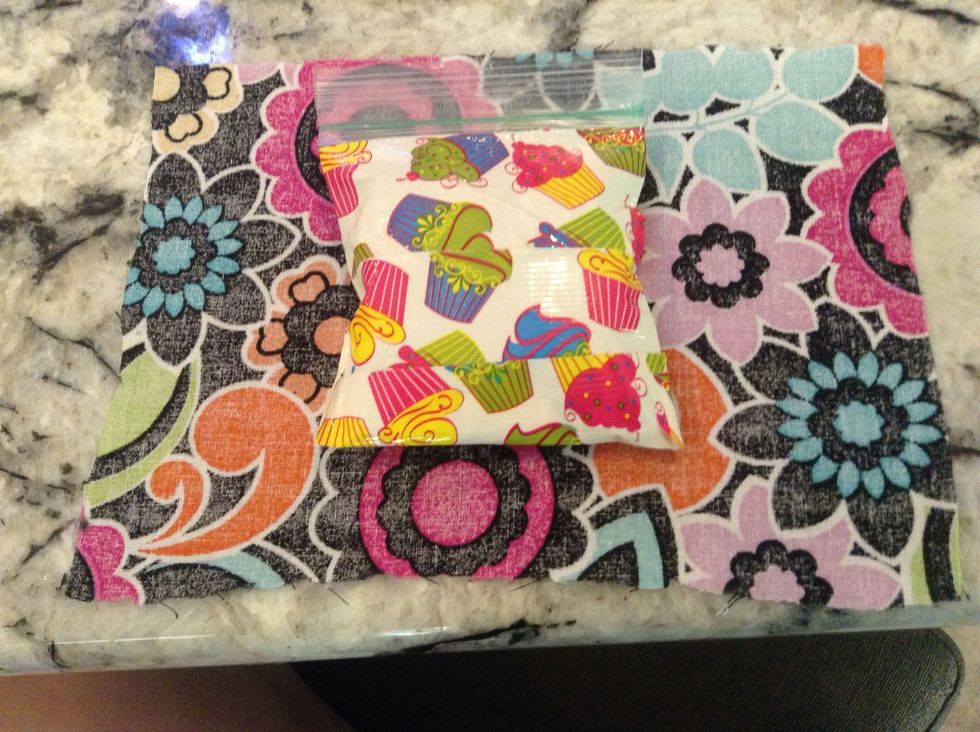 Flip the Piece of fabric over and put the bag of ice in the middle of it
