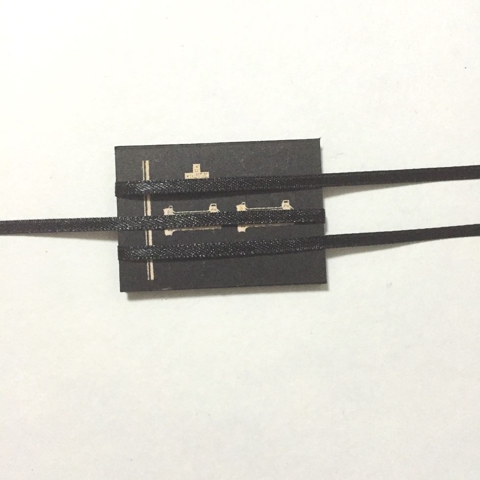 Flip the ribbons over the 2nd number block as shown...