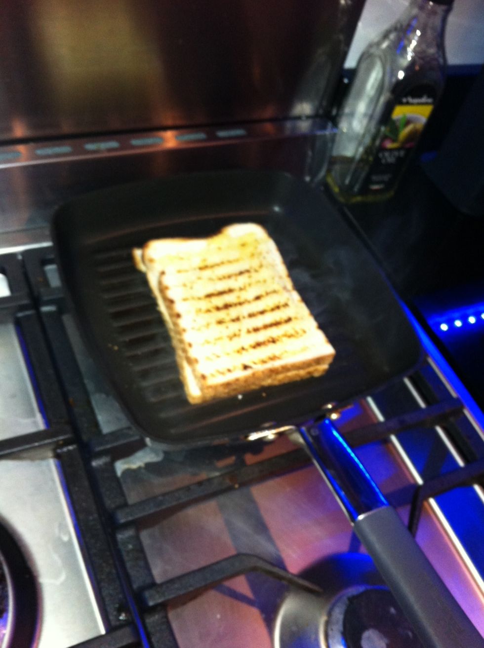 Flip the sandwich with a spatula.