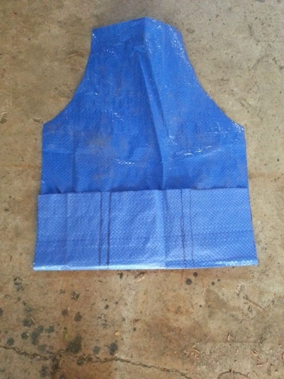 Flip the tarp over so the marker lines are face down. Fold the bottom up and make a crease in the tarp so the "pocket" is the height you want. Mine = about 5.5". My "pocket" will have 3 compartments
