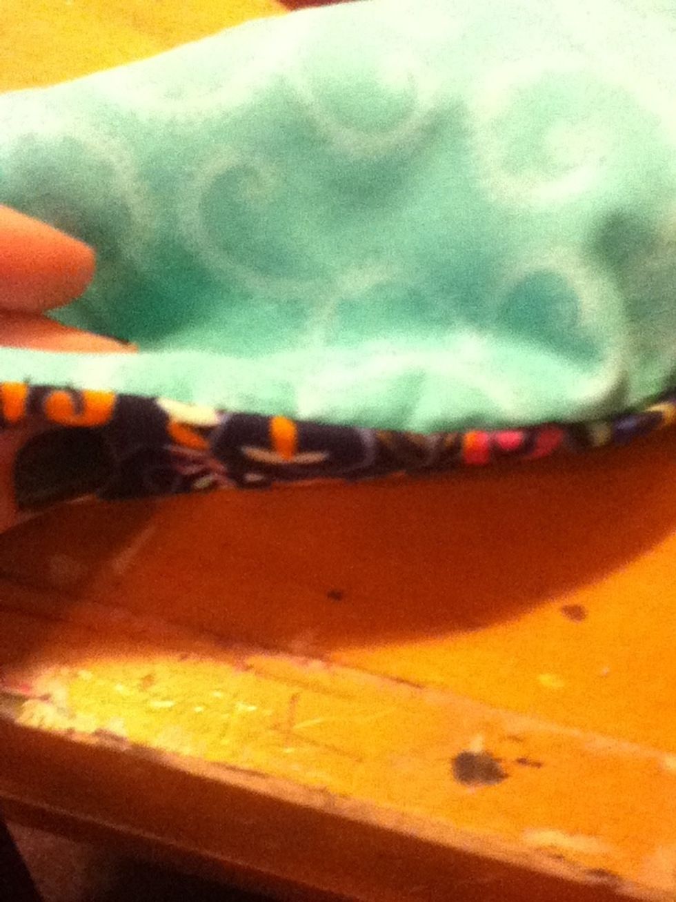 Flip them inside out. If you did it right, both of the bright sides of the fabrics should be out and you should have an opening at the top