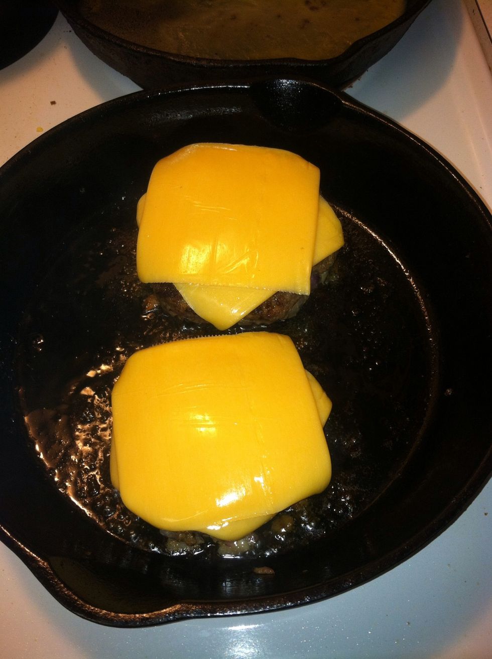 Flip them over after half of it is cooked. I like to add the cheese not long after I flip the burgers over so they don't burn waiting for the cheese to melt.