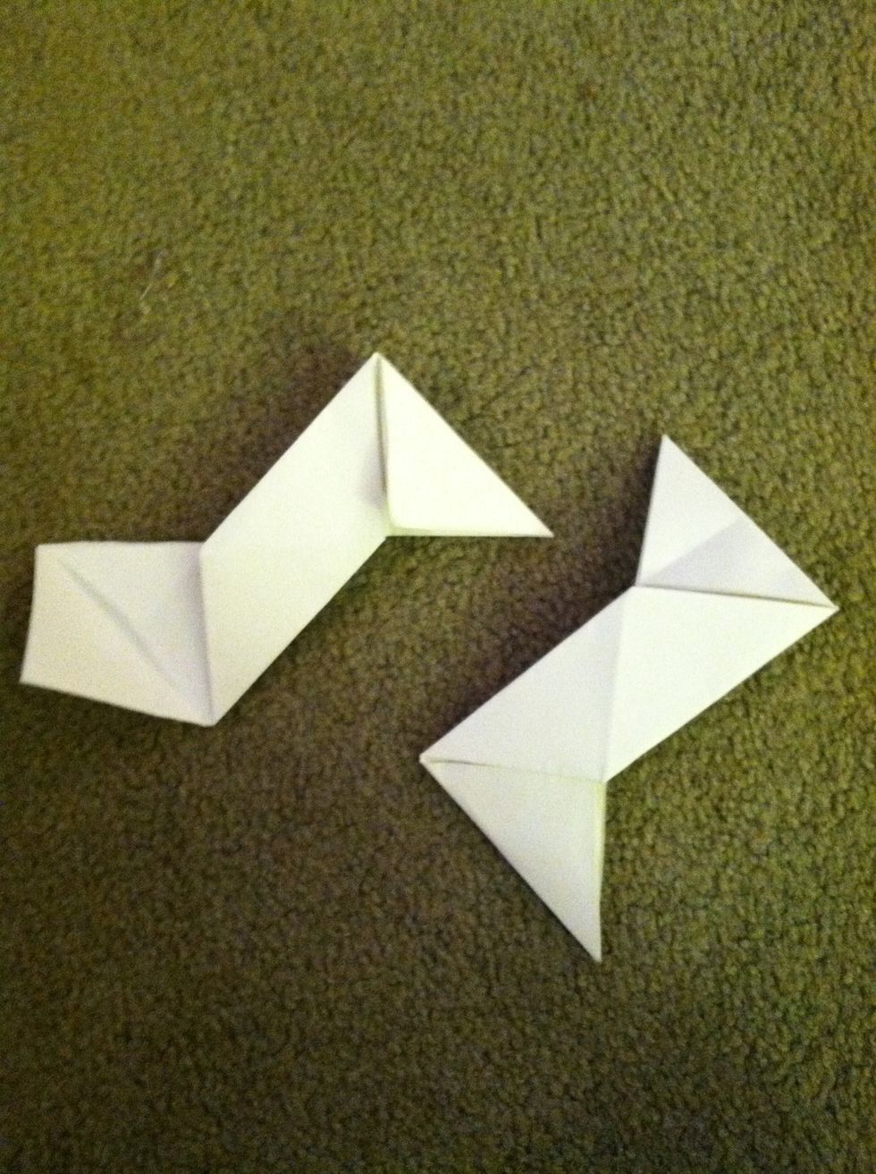 Flip them over and fold the squares coming off the side to make a triangle. Make sure it sticks out like in the picture.