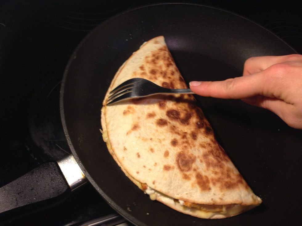 Flip tortilla and press lightly with a fork