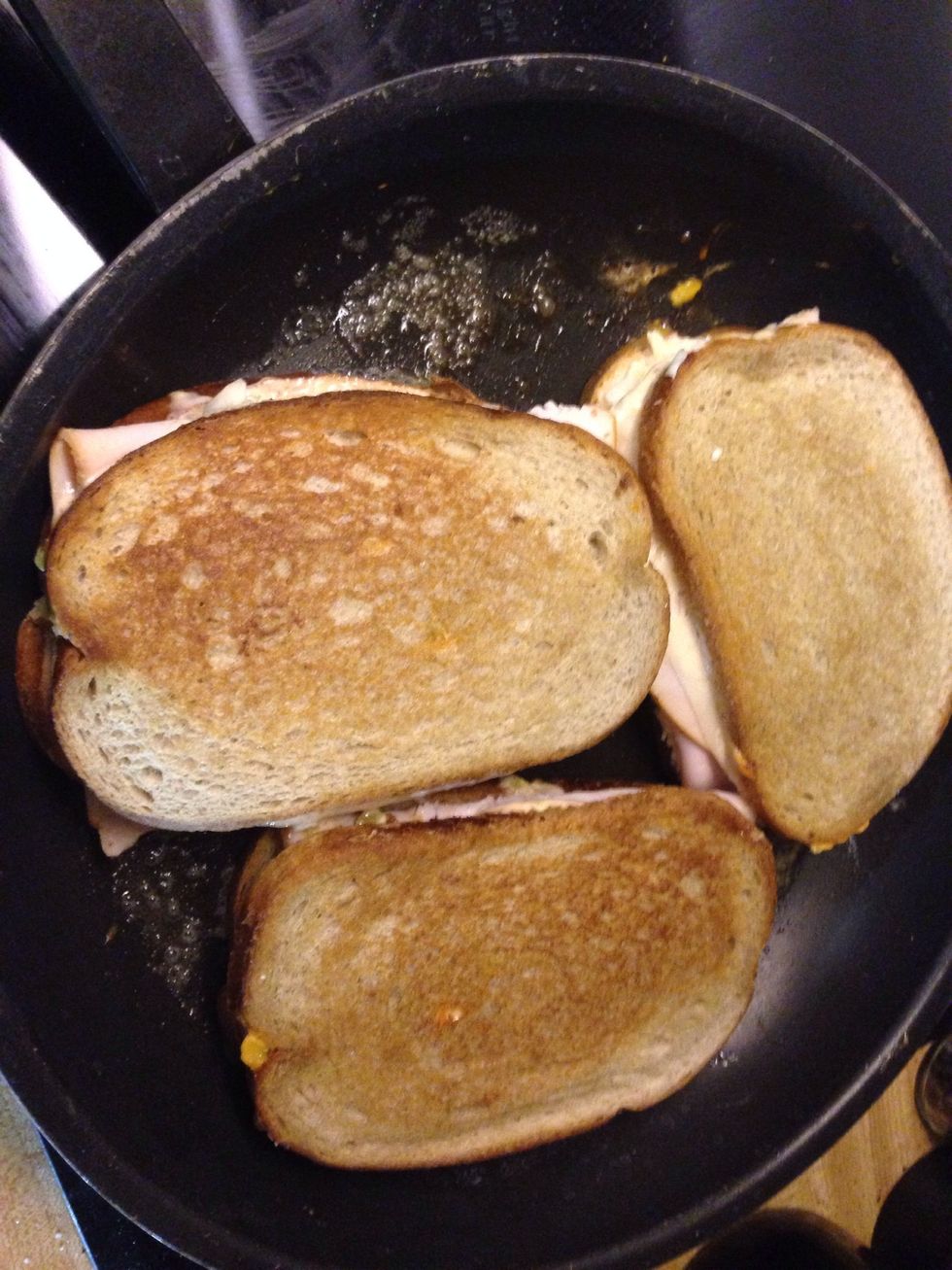 Flip when it's golden brown. Add butter to the pan again before putting the new side down. Make sure both sides are toasty and the cheese is melted.