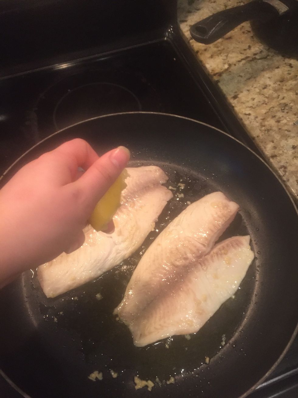Flip your fish, season with salt, pepper & lemon. (Do this on both sides)