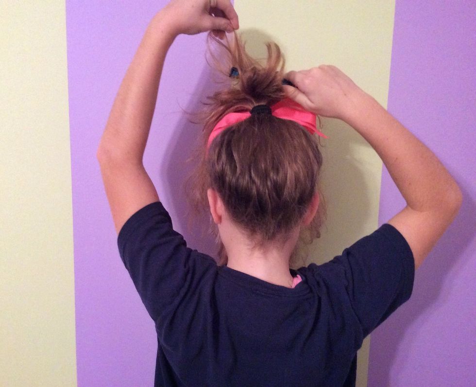 Flip your hair over and begin teasing it from the bottom to the top.