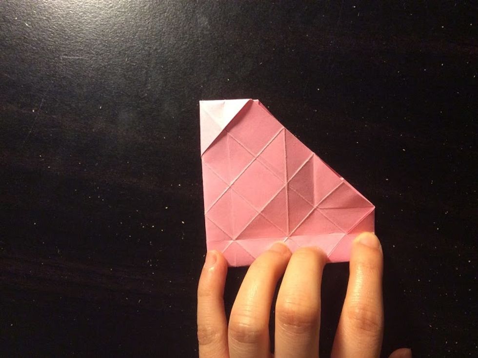 Flip your paper over and fold it in half, then in half again.