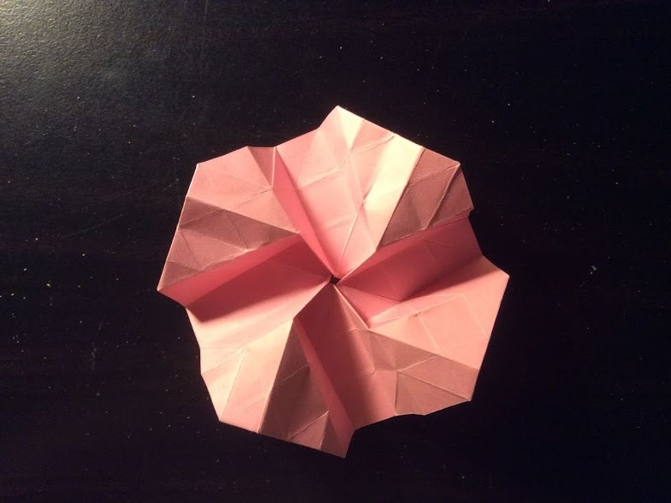 Flip your paper over and with your ring finger, gently pop the folded corners up.