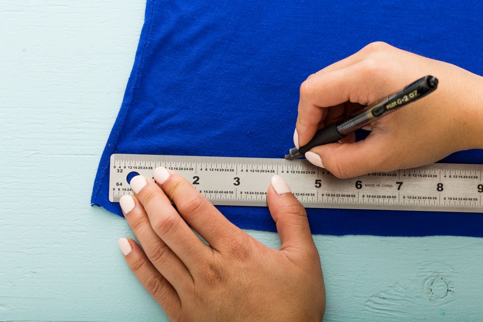 Flip your t-shirt inside out. Determine where you want your bag to end and trace a line across. Keep in mind that your tote is likely to stretch and become longer when it\u2019s filled with things.