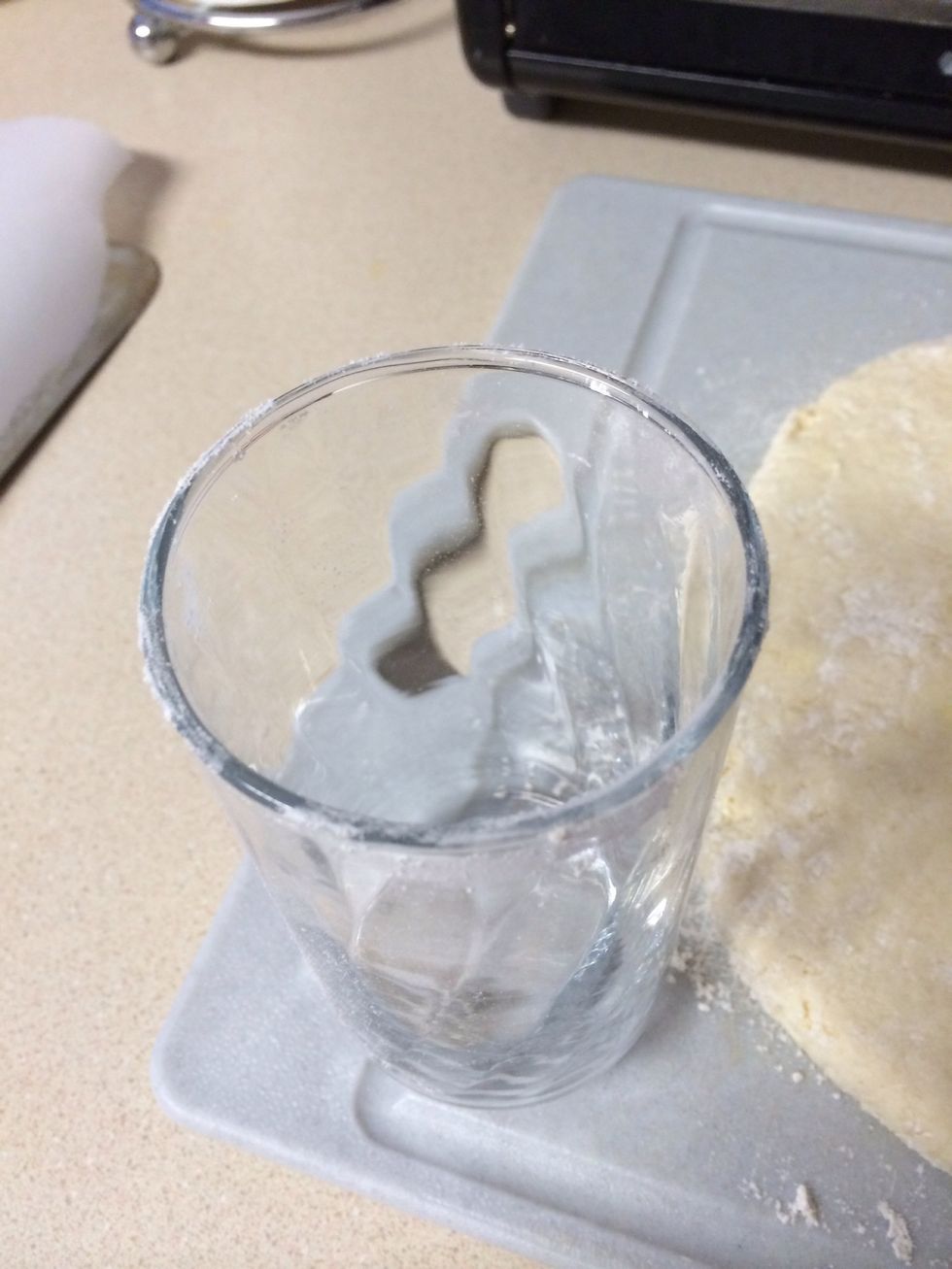 Flour the top of a glass or circular cookie cutter