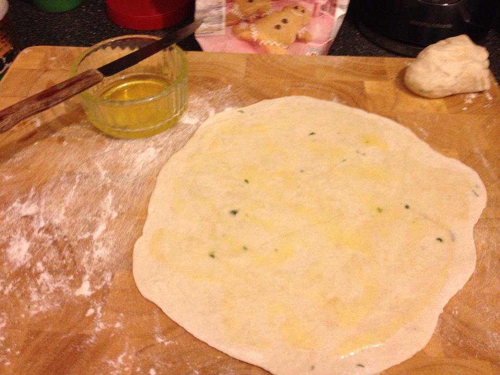 Flour your board and roll out one ball to a thickness of 2-3 mm then take your Ghee and spread it across the chapatti.