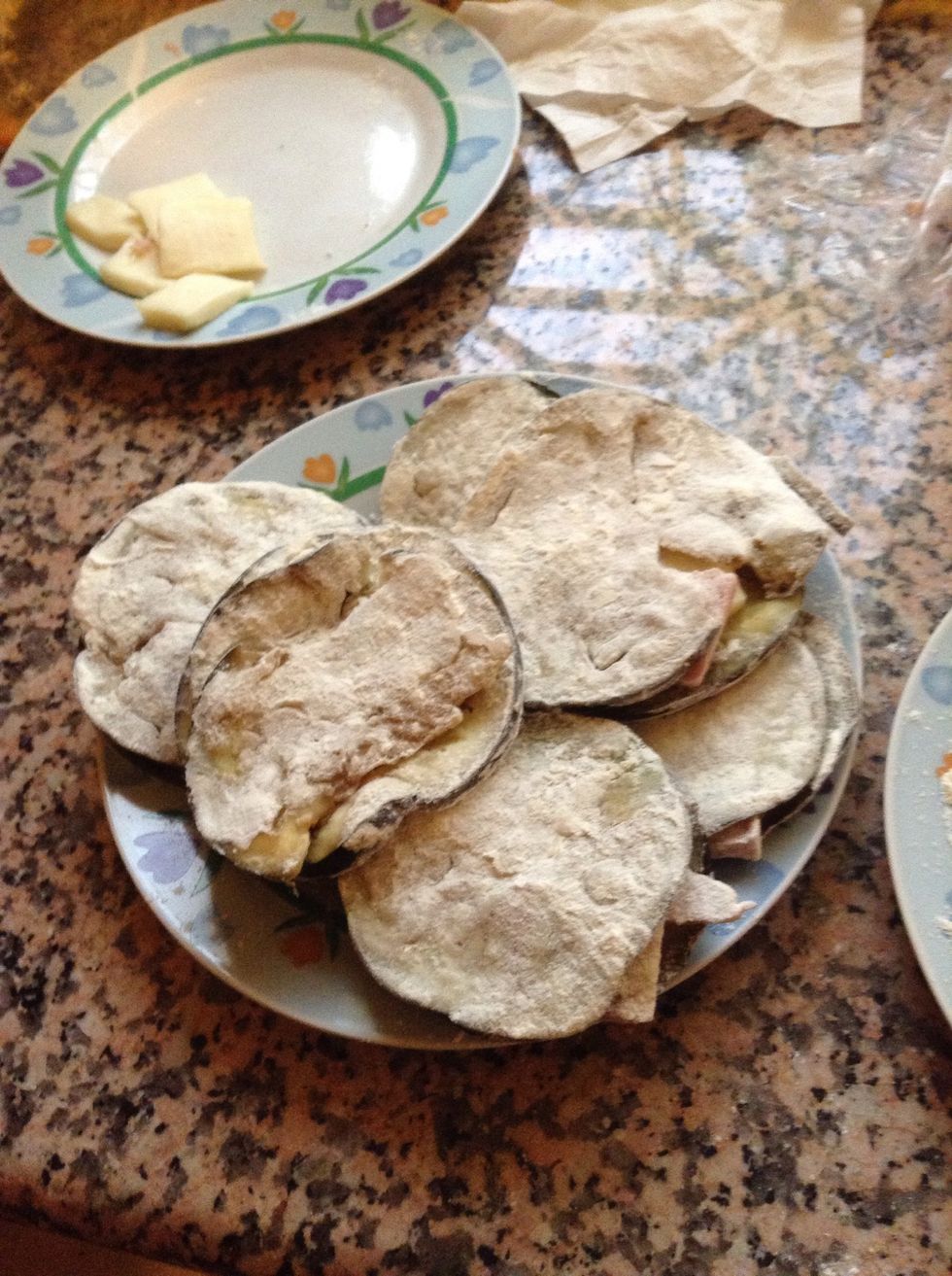 Flour your eggplant cordon bleu on both sides.