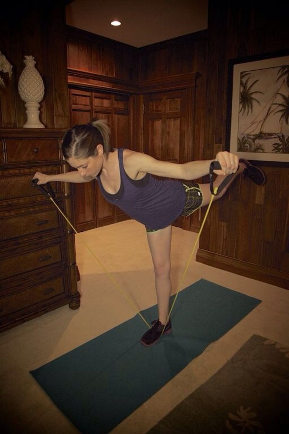 Fly-Back/Kick-Back: Hold the ends of the bands with each hand and extend leg back as you bend body forward, lift arms to the side. Continue for 1 minute, then switch left leg in the next circuit. :