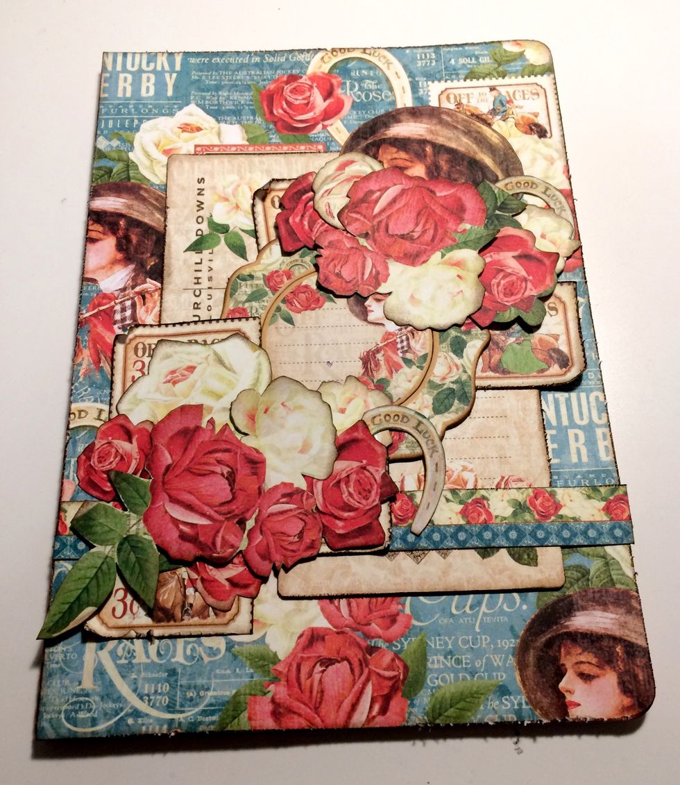 Foam square the large rose with horseshoe, set of three roses, one small white rose and two small red roses as desired in the bottom left hand corner filling in the holes between the stamps.