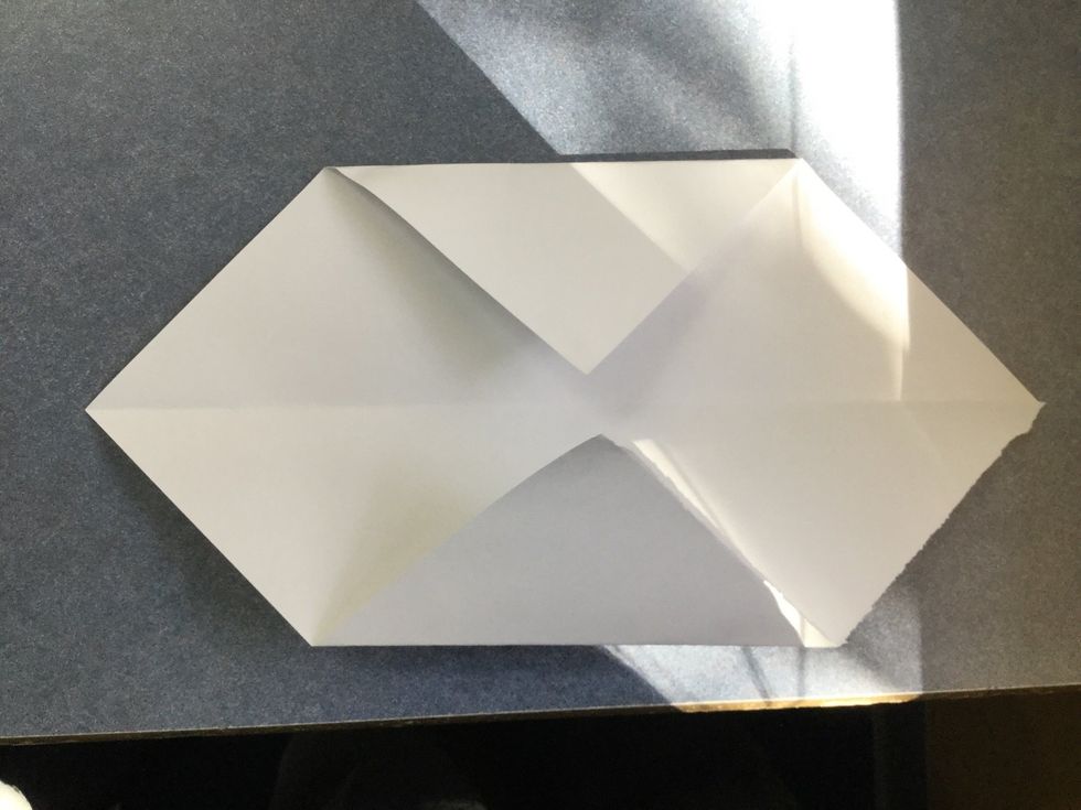 Fold 2 opposite corners to the centre as shown.