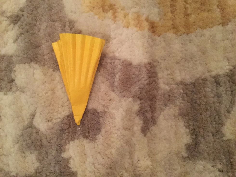 Fold a large cupcake liner in half four times with the folded point at the bottom.